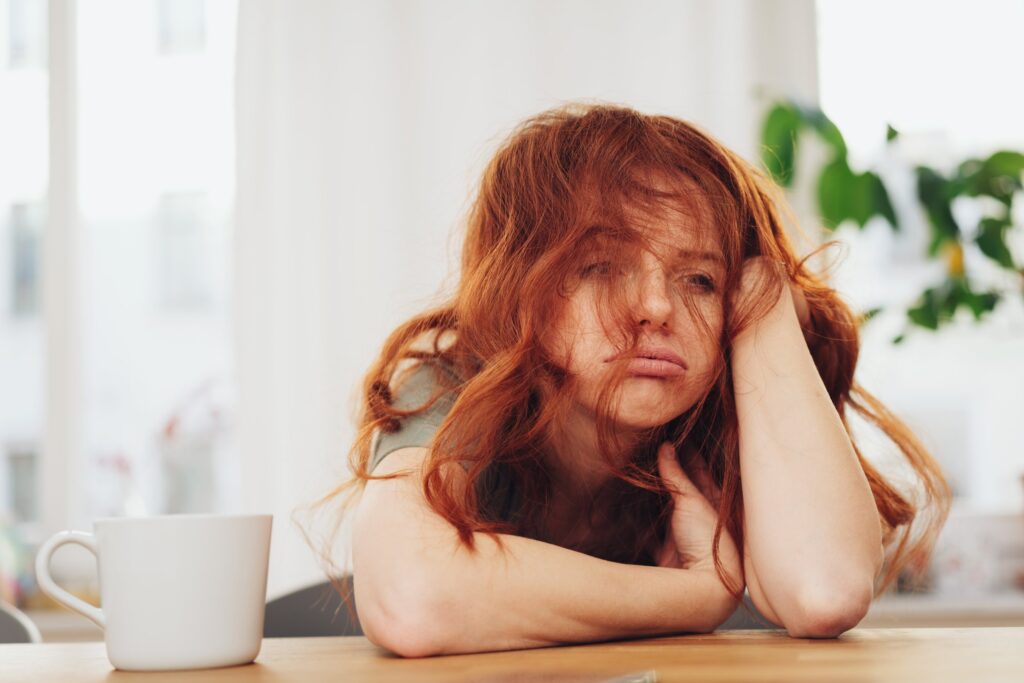 woman with red hair is tired
