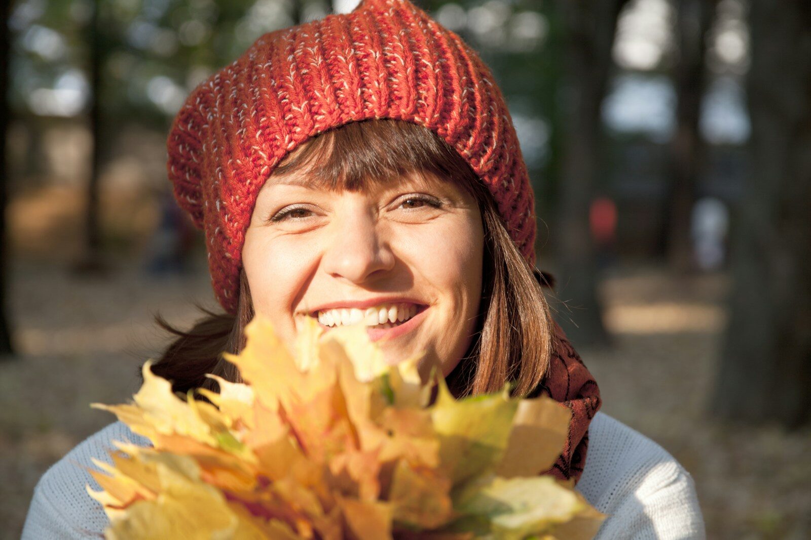 A woman holding a bunch of leaves in her hands